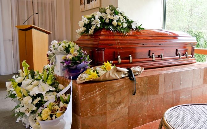funeral coffin with flowers as part of a funeral service