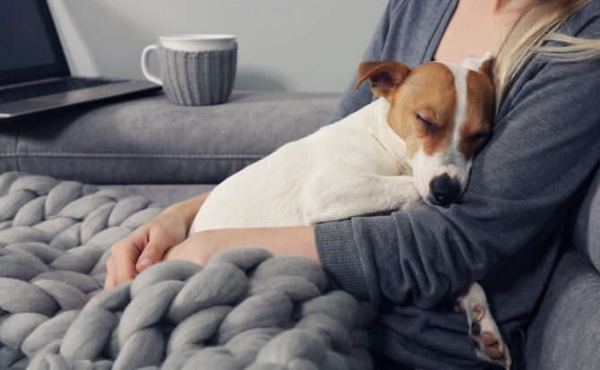 Woman Hugging Sleeping Dog